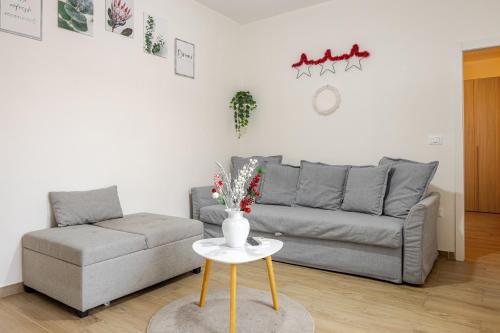 a living room with a couch and a table at Baracca Apartment in Massa Lombarda