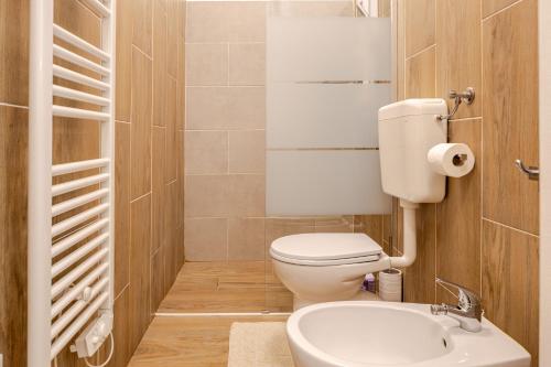 a small bathroom with a toilet and a sink at Baracca Apartment in Massa Lombarda