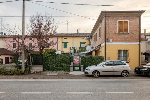 a silver car parked on the side of a street at Baracca Apartment in Massa Lombarda