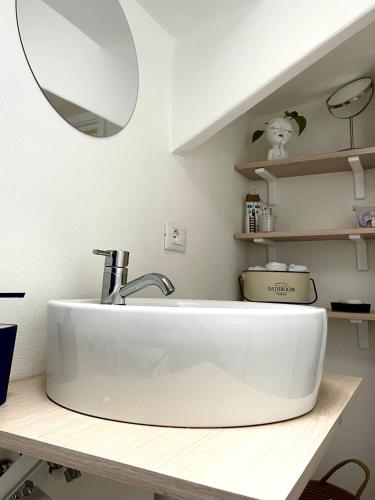 a bathroom with a white sink and a mirror at La casa al mare in Alassio