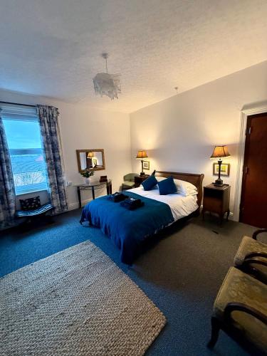 a bedroom with a bed and a large window at Sunset Hideaway, Bridlington in Bridlington