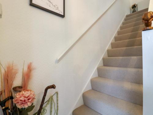 a staircase in a house with a picture on the wall at Olicana Croft in Ilkley
