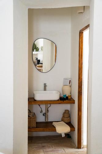 a bathroom with a sink and a mirror at Casablanca Vejer Baño Termal in Vejer de la Frontera