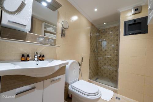 a bathroom with a toilet and a sink and a shower at Luxury Chaouen in Chefchaouene