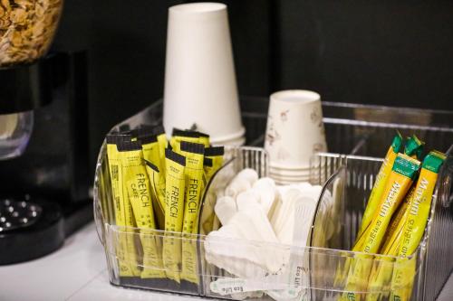 a basket with toilet paper and other items on a counter at Hotel Kkuljam Stay in Jinju