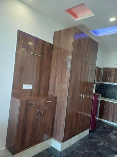 two large wooden cabinets in a room at Uday Sunset View Villas By Royal Collection Hotels in Nainital