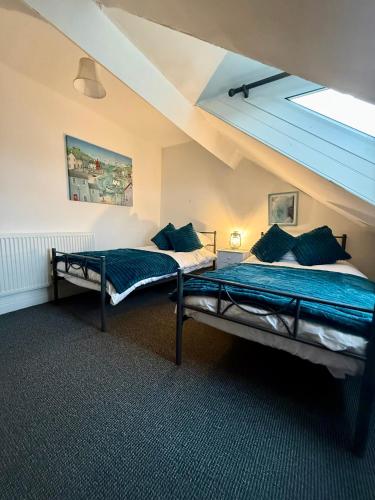 a bedroom with two beds in a attic at Sunset Hideaway, Bridlington in Bridlington