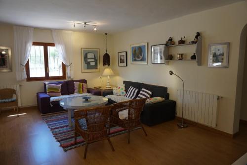 a living room with a couch and a table at Casa la Paloma in Es Caló