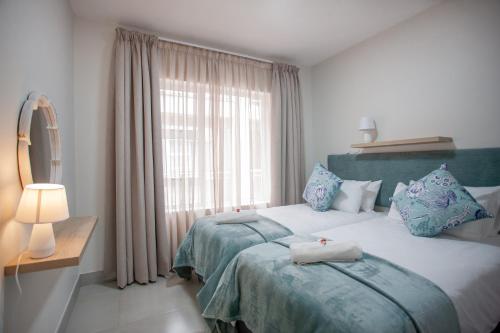 a bedroom with a large bed and a window at Apartment 60 A & B - 1 On York in George