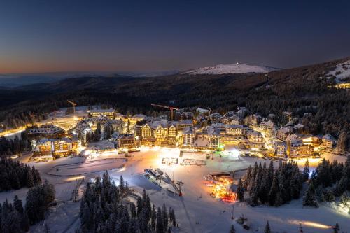 an aerial view of a resort in the snow at night at GONDOLA Apartment Košuta Iva in Brzeće