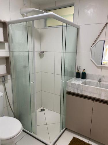 a bathroom with a shower and a toilet and a sink at Vog caruaru in Caruaru