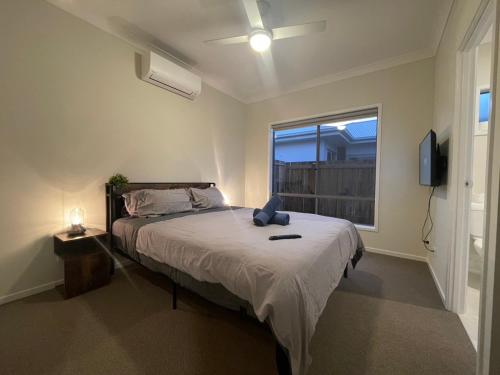 a bedroom with a large bed and a window at Charming Home in Griffin for Unforgettable stay in Griffin