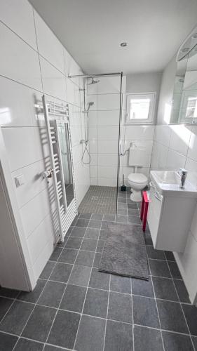 a bathroom with a toilet and a sink at Little Cottage Merbeck in Wegberg