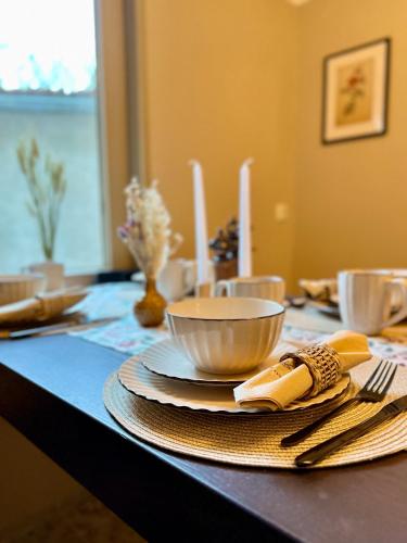 a table with a bowl and plates and utensils at Ferienhaus am Markt - ANNO 1708 - App 2 in Aschersleben