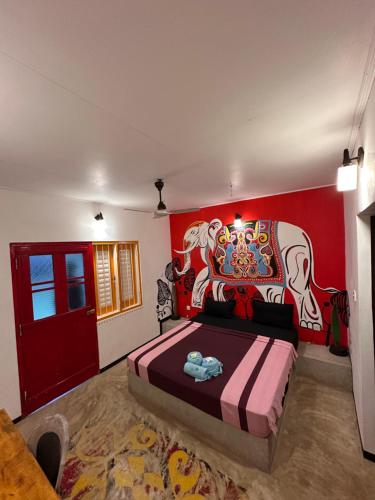 a bedroom with a bed with a painting on the wall at PointBreak Resort in Kalpitiya