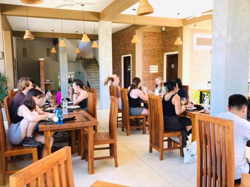a group of people sitting at a table in a restaurant at Ali Weta Safari Resort in Udawalawe