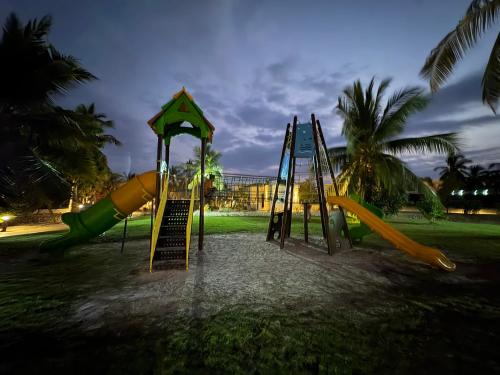a playground with a slide and a slideintend at Villa Davelin, Hawana Salalah in Salalah