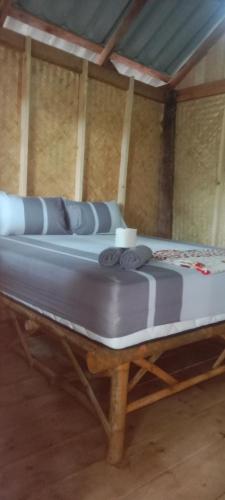 a large mattress on a wooden table in a room at Som PalmGarden in Ko Lanta