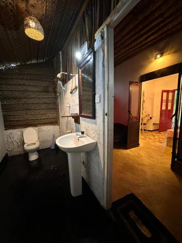 a bathroom with a sink and a toilet at PointBreak Resort in Kalpitiya