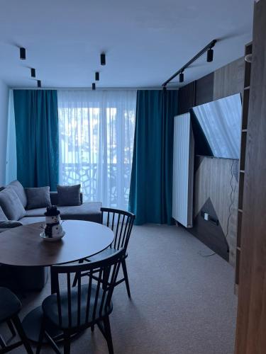 a living room with a table and a couch at La Familia in Jahorina