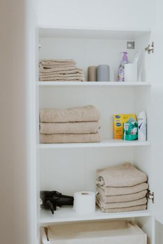 a shelf with towels and other items in a bathroom at Moderne Wohnung in Dernbach WW in Dernbach