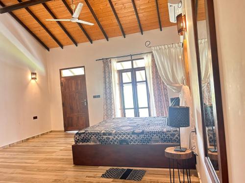 a bedroom with a bed and a window at Blu Marine Nilaveli in Trincomalee