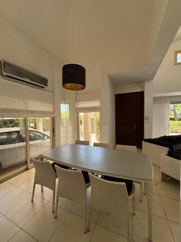 a dining room with a table and chairs at Beautiful Villa in Latchi in the best location! in Neo Chorio