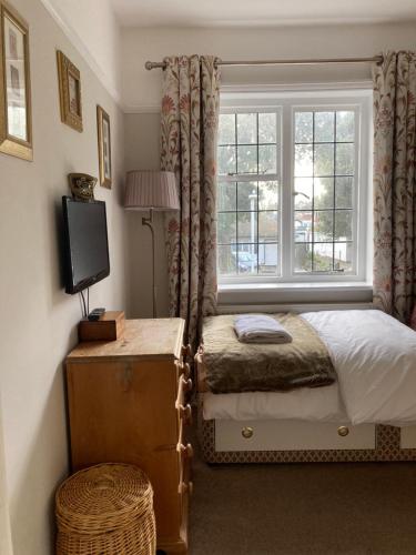 a bedroom with a bed and a window at The mole hole in Kent