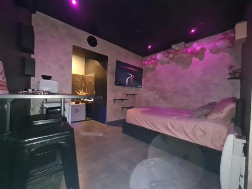 a room with a bed with a purple wall at 2eme in Lyon