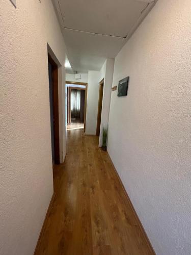 an empty hallway with white walls and wooden floors at Apartment Mila in Plitvička Jezera