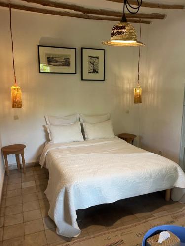 a bedroom with a white bed in a room at La Ferme Berbere Adult only in El Harkat