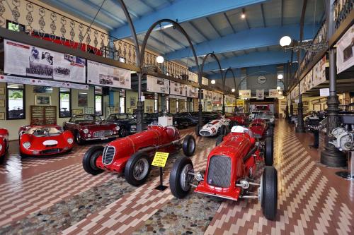 a bunch of red cars parked in a building at Central Park Hotel Modena in Modena