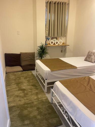 a room with three beds and a couch in it at Tota house in dahab in Dahab