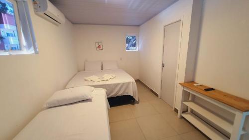 a small room with a bed and a window at iG Pousada - Frente Mar in Florianópolis