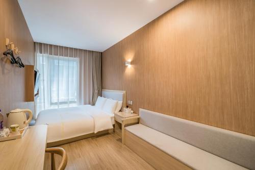 a hotel room with a bed and a window at Dequan Hotel Guangqumen Outer Branch in Beijing