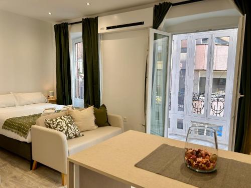 a living room with a couch and a table at INSIDEHOME Ciudad del Cine a 3 minutos de la Plaza Mayor in Valladolid