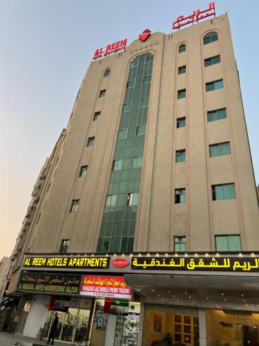 a large building with a sign in front of it at Al Reem Hotel Apartments in Sharjah