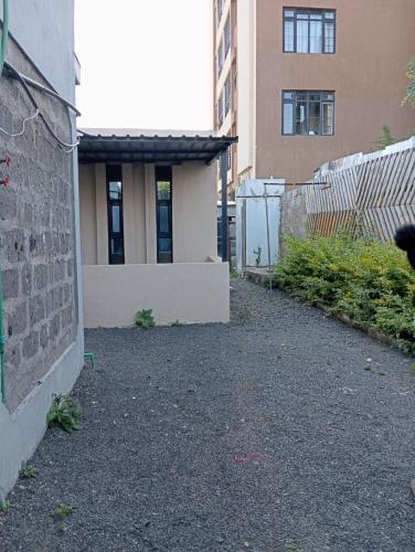 a building with a fence in front of a building at Traven Homes - 1BR Unit in Nairobi