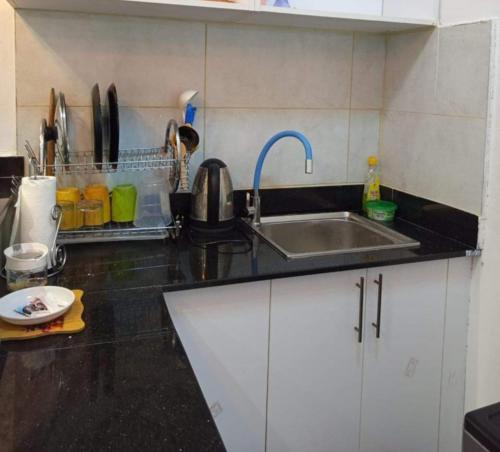 a kitchen with a sink and a counter top at Traven Homes - 1BR Unit in Nairobi