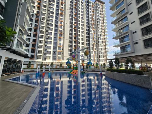 a swimming pool in front of some tall buildings at K Avenue Sunset View Condomonium - Kota Kinabalu Airport in Kota Kinabalu