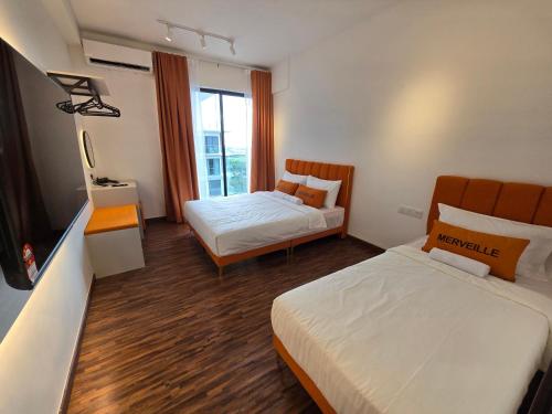 a hotel room with two beds and a window at K Avenue Sunset View Condomonium - Kota Kinabalu Airport in Kota Kinabalu