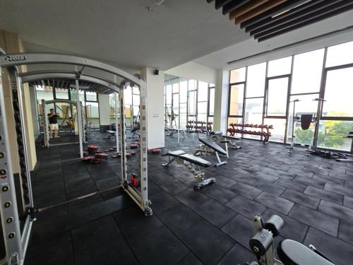 a gym with a large room with benches and machines at K Avenue Sunset View Condomonium - Kota Kinabalu Airport in Kota Kinabalu