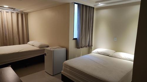 Кровать или кровати в номере Suítes Cabo Frio