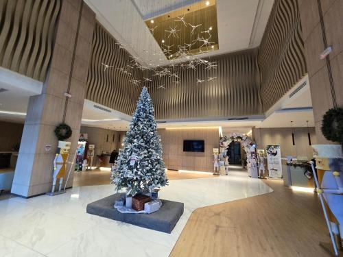 a christmas tree in the middle of a building at K Avenue Sunset View Condomonium - Kota Kinabalu Airport in Kota Kinabalu