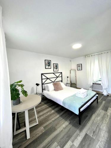 a bedroom with a large bed and a table at Stylish 1q Unit With Pool 11 Handicap Access in Clearwater