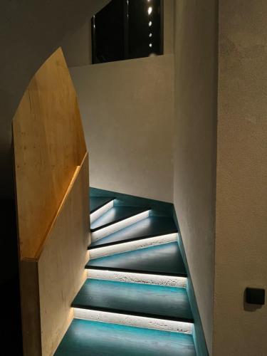 a staircase in a building with a blue floor at Котеджі Грань in Bukovel