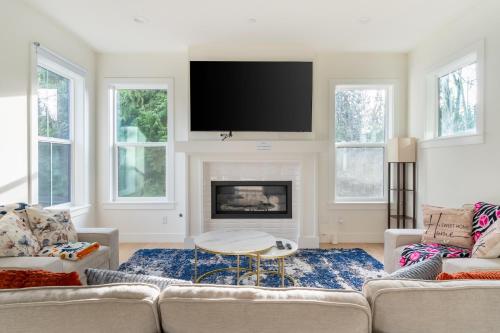 a living room with a couch and a fireplace at Elegant 3-Story House with Private Backyard in WA in Kirkland