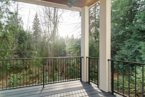 a screened porch with a view of the woods at Elegant 3-Story House with Private Backyard in WA in Kirkland