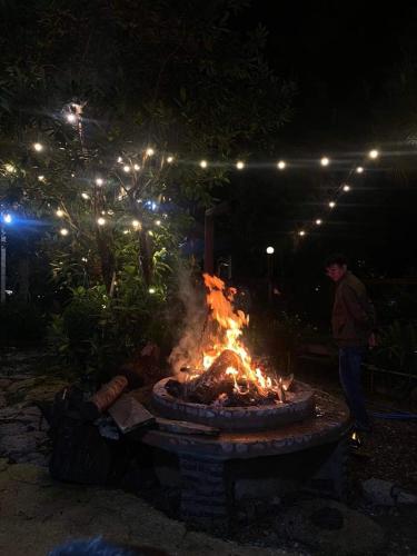 a fire pit in a yard at night at Balabum home and more in Trai Mat