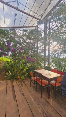 a table and chairs sitting on a wooden deck at Balabum home and more in Trai Mat